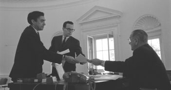 A partir da esquerda, Richard N. “Dick” Goodwin, Bill Moyers e o presidente Lyndon B. Johnson no Salão Oval em 1965. (Yoichi Okamoto/foto oficial da Casa Branca/Biblioteca LBJ)