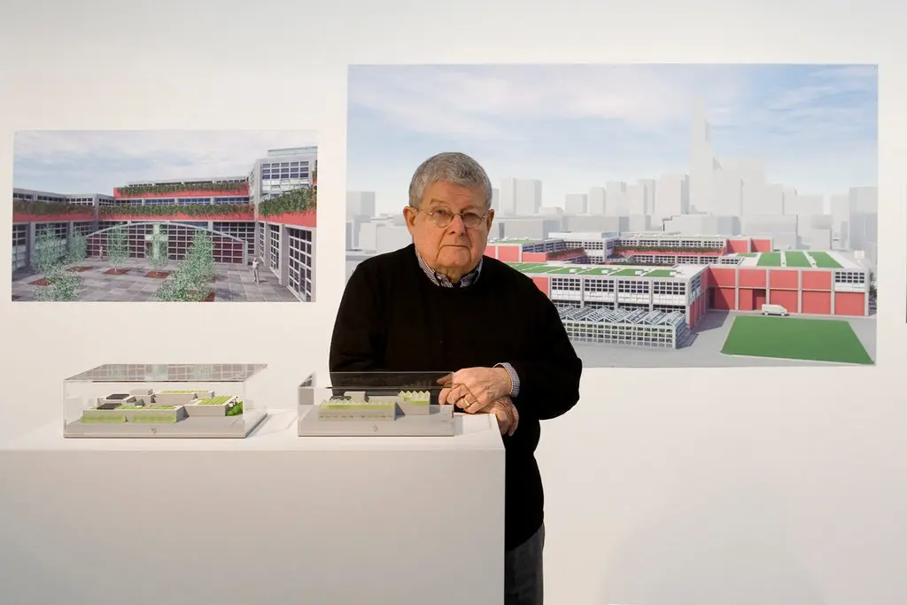 Stanley Tigerman com modelos e representações de seu edifício Pacific Garden Mission, um abrigo para moradores de rua em Chicago.Crédito...William Zbaren para o The New York Times