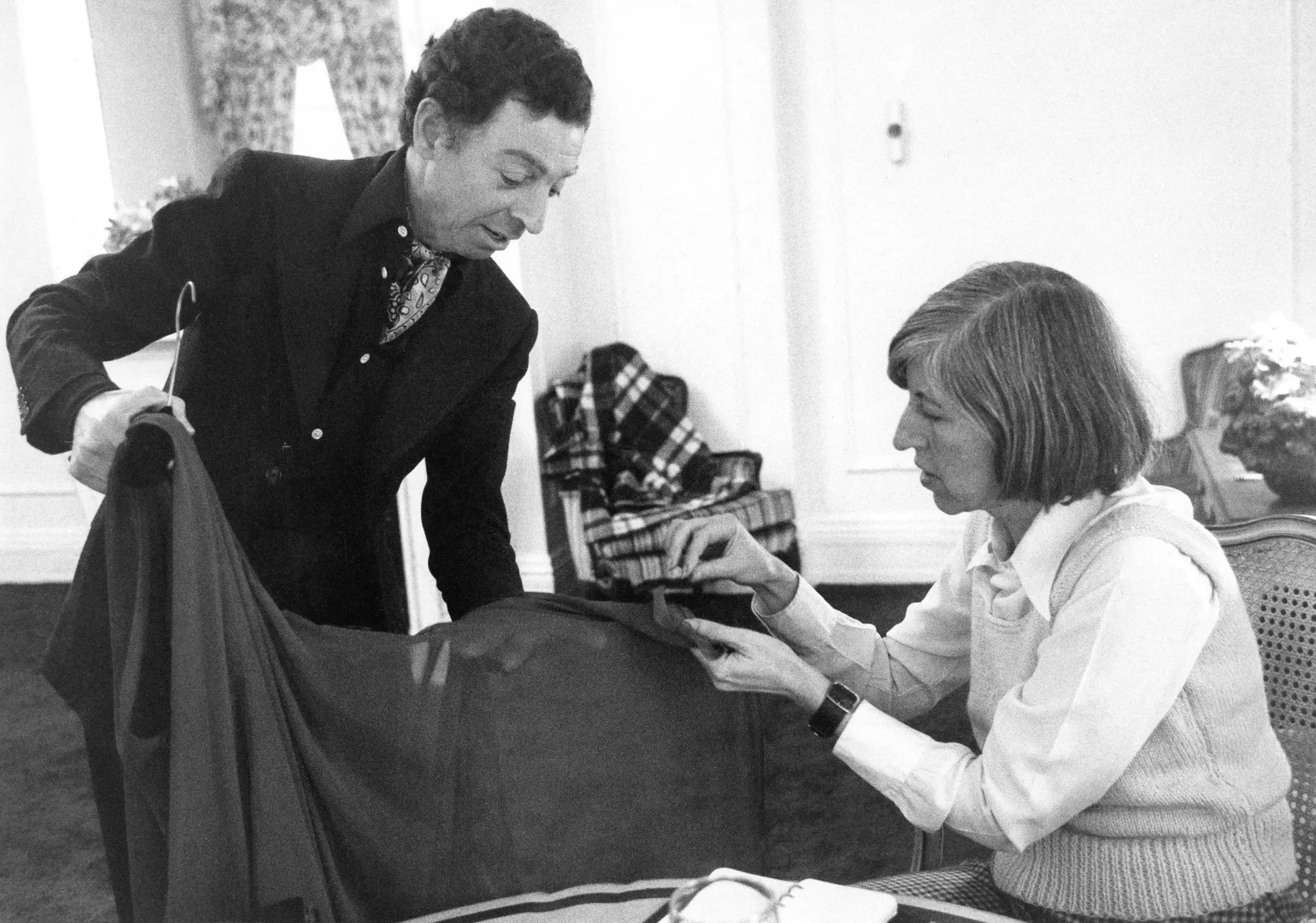 Bernadine Morris inspecionando o trabalho do designer James Galanos durante uma entrevista com ele para o The New York Times no Plaza Hotel em Manhattan em 1974.Crédito...O jornal New York Times